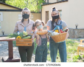 A Woman With Two Daughters With Food Packages For The Socially Vulnerable Segments Of The Population.