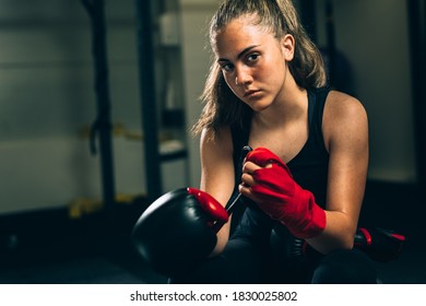 Woman Tying Boxing Gloves Indoor