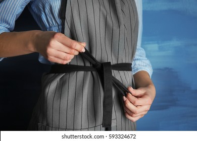 Woman  tying up her apron around the waist - Powered by Shutterstock