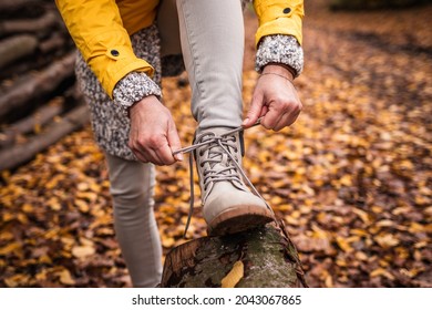 Woman Tying Shoelace On Her Hiking Boot. Tourist Is Getting Ready For Autumn Hike At Forest Trekking Trail