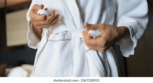 Woman tying White Bathrobe after shower, living lifestyle - Shutterstock ID 2367228931