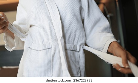 Woman tying White Bathrobe after shower, living lifestyle - Shutterstock ID 2367228933