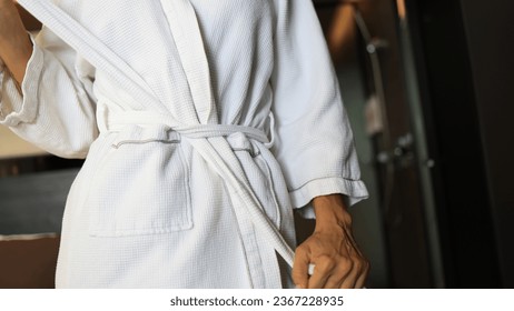Woman tying White Bathrobe after shower, living lifestyle - Shutterstock ID 2367228935