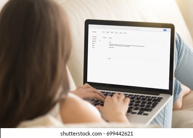 Woman typing electronic message to partner on laptop while working from home, writing commercial e-mail, composing offer in e letter, contacting client online, mail for business, close up rear view