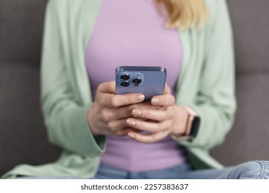 Woman typing message in smart phone app. Close up photo of unrecognizable adult female person using mobile phone for communication
