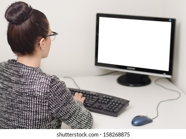 woman typing on a computer with a white screen