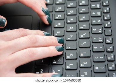 Woman typing on laptop keyboard