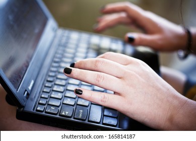 Woman Typing On A Laptop Keyboard