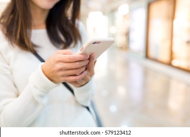 Woman typing text message on cellphone