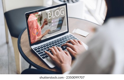 Woman ues laptop computer with social media online content, freelance worker, working online, content creator, blogger, technology, website, woman reading blog online on computer at home - Shutterstock ID 2350099707