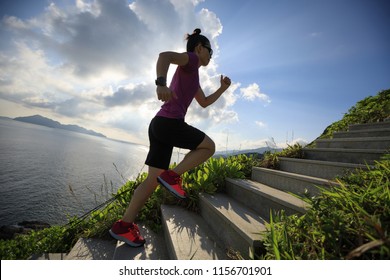 Woman Ultra Marathon Runner Running Up On Seaside Mountain Stairs