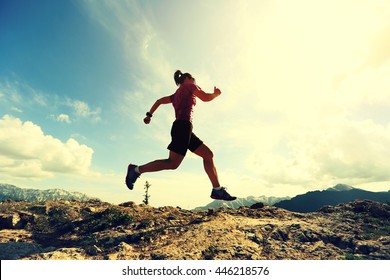 Woman Ultra Marathon Runner Running On Beautiful Mountain Peak