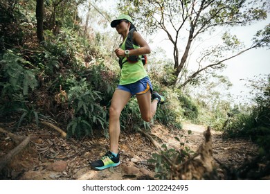 Woman Ultra Marathon Unner Running On Tropical Forest Trail