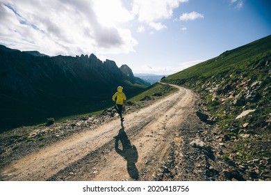 Woman Ultramarathon Runner Running At Mountain Top