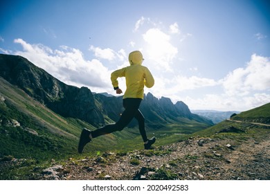 Woman Ultramarathon Runner Running At Mountain Top