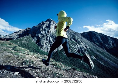 Woman Ultramarathon Runner Running At Mountain Top