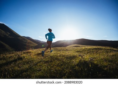 Woman Ultramarathon Runner Running At Mountain Top