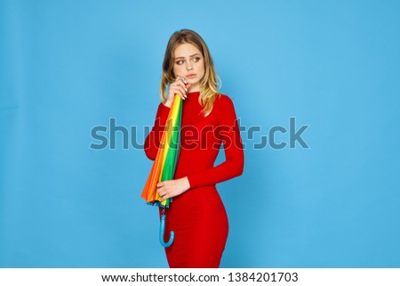   woman with umbrella on blue background                           