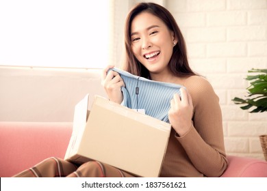 Woman Unboxing New Clothes Delivered. Concept Online Shopping.