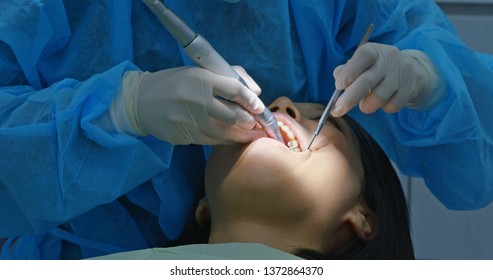 Woman Under Dental Check Up In Clinic