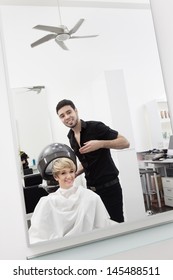 Woman Under Hair Dryer At Beauty Salon