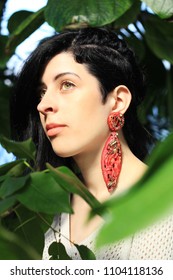 Woman With Undercut Hairstyle Wearing Red Silk Earrings. Fashion Portrait.