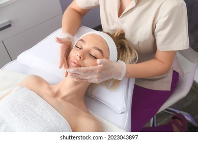 Woman Undergoing Cosmetic Procedure In Beauty Salon