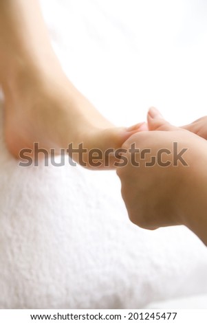 The woman undergoing foot massage
