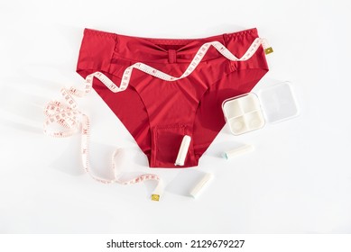 Woman Underpants, Tampons And Metric Measuring Tape. Concept Of Premenstrual Syndrome, Critical Days, Abdominal Pain And Bloating. Menstruation, Menstrual Cycle, Women's Health, Feminine Hygiene, Pms.