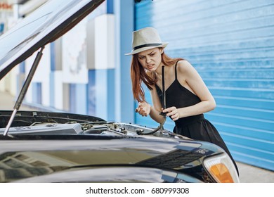 Woman Understands The Hood Of The Car, Oil Change, Engine, Body Shop                               