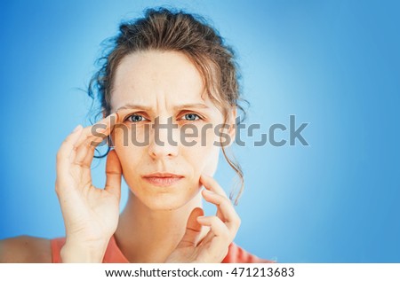 woman unhappy with her mimic wrinkles on face