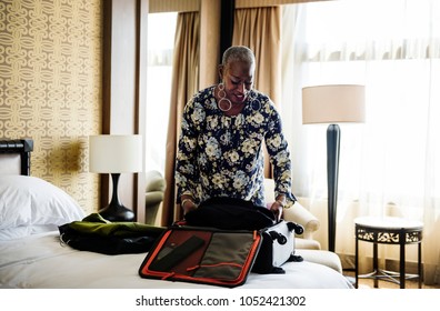 Woman Unpacking Her Suitcase