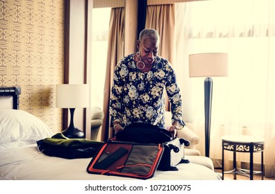 Woman Unpacking Her Suitcase