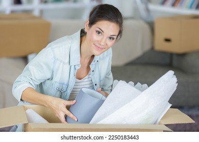 woman unpacking or packing moving boxes - Shutterstock ID 2250183443