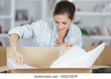 Woman Unpacking Unboxing Cardboard Carton