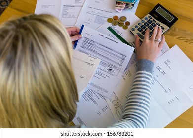 a woman with unpaid bills has many debts. unemployment and personal bankruptcy - Shutterstock ID 156983201