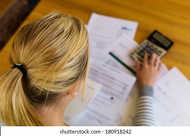 a woman with unpaid bills has many debts. unemployment and personal bankruptcy - Shutterstock ID 180918242