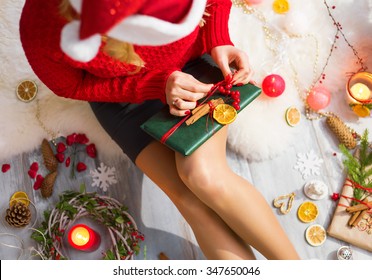 Woman Unwrapping Christmas Gifts