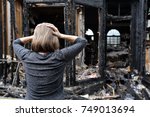 A woman is upset about her house which has burned down.