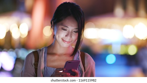 Woman use of cellphone in the city in the evening - Powered by Shutterstock