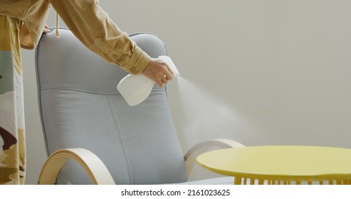 Woman Use Detergent Spray For Cleaning The Chair At Home