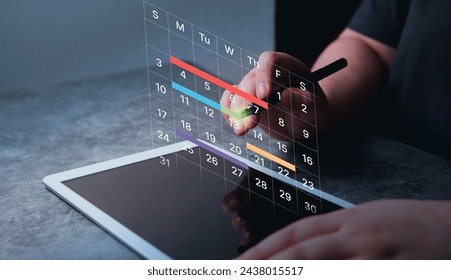 Woman use digital tablet to mark dates on virtual hologram calendar. Businesswoman managing her business schedule. Setting reminders and appointments concept. Planning ideas. - Powered by Shutterstock