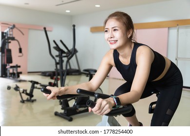 Woman Use Exercise Bike And Training