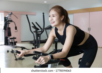 Woman Use Exercise Bike And Training