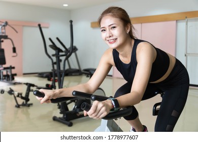 Woman Use Exercise Bike And Training