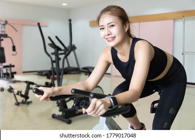 Woman Use Exercise Bike And Training