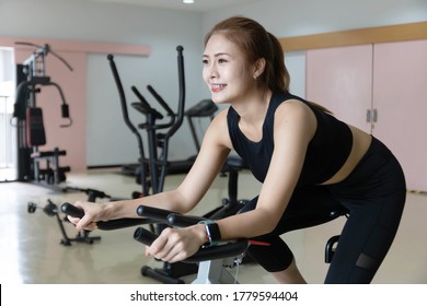 Woman Use Exercise Bike And Training