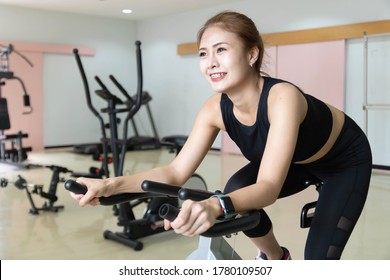 Woman Use Exercise Bike And Training