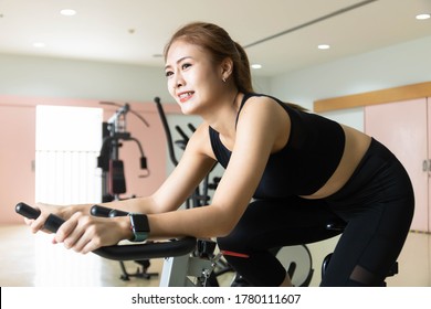 Woman Use Exercise Bike And Training