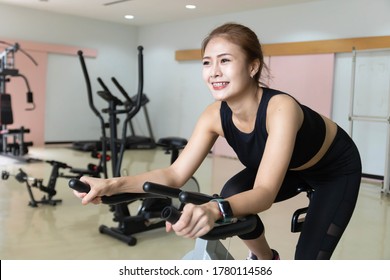 Woman Use Exercise Bike And Training